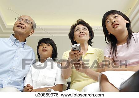 Stock Photograph - Elderly couple and grandchildren. Fotosearch