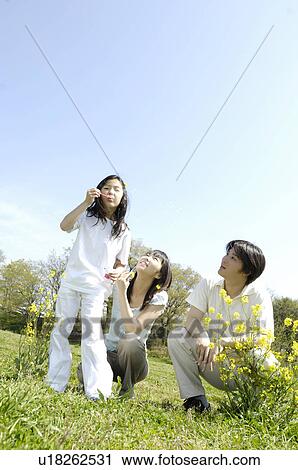 Stock Image - Family on the grassland. Fotosearch