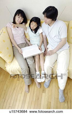 Family which relaxes at the living room View Large Photo Image Picture - Family which relaxes at the living room. Fotosearch