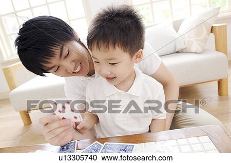 Father and son playing card game View Large Photo Image Stock Image - Father and son playing card game. Fotosearch