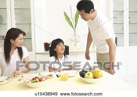 Stock Photo - Parent and child eating a meal. Fotosearch