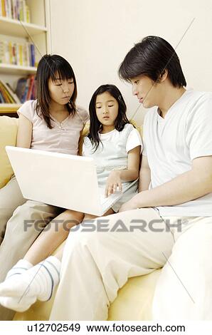 Stock Photo - Parent and child operating a PC. Fotosearch