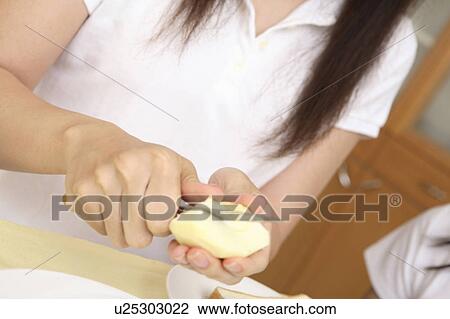 Hand peeling the apple View Large Photo Image Stock Image - Hand peeling the apple. Fotosearch