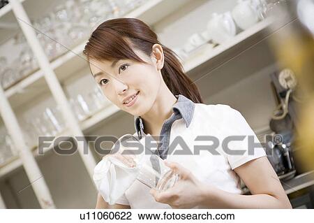 Stock Image - Sales person in the coffee shop. Fotosearch
