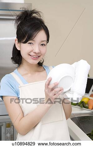 Stock Photo - Scene of woman cooking. Fotosearch