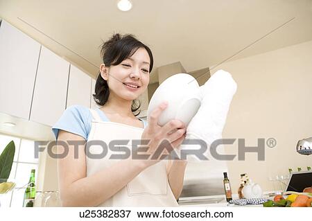 Stock Photo - Scene of woman cooking. Fotosearch