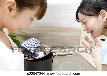 Picture - Scene of women cooking. Fotosearch