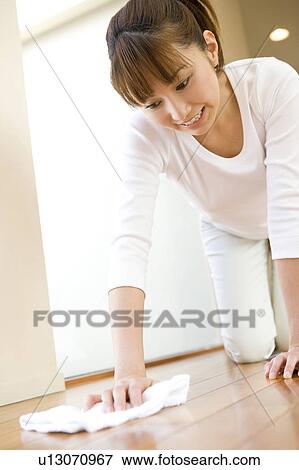 Stock Photo - Woman cleaning a floor. Fotosearch