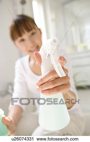Stock Image - Woman cleaning bathroom. Fotosearch