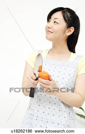 Stock Photograph - Woman cutting vegetables. Fotosearch