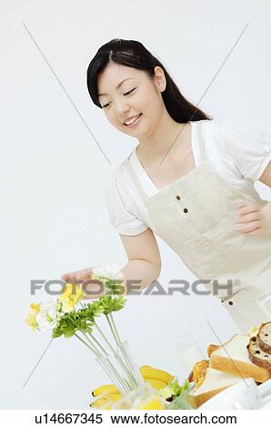 Stock Photography - Woman decorating the flower. Fotosearch