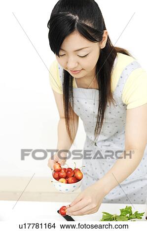 Picture - Woman having cherries. Fotosearch