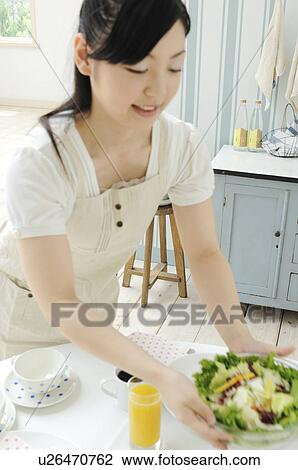 Woman preparing for the meal View Large Photo Image Stock Image - Woman preparing for the meal. Fotosearch