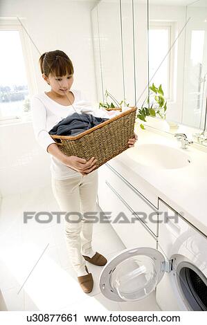 Stock Image - Woman washing clothes. Fotosearch