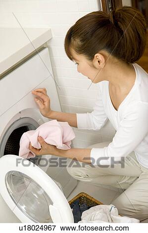 Stock Photo - Woman washing clothes. Fotosearch