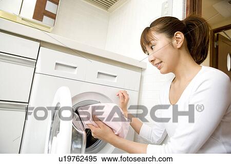 Stock Photography - Woman washing clothes. Fotosearch