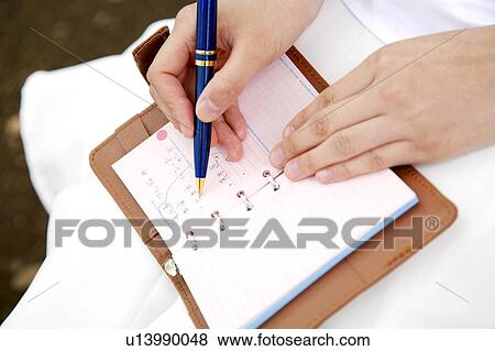 Stock Photo - Woman who attends a notebook. Fotosearch