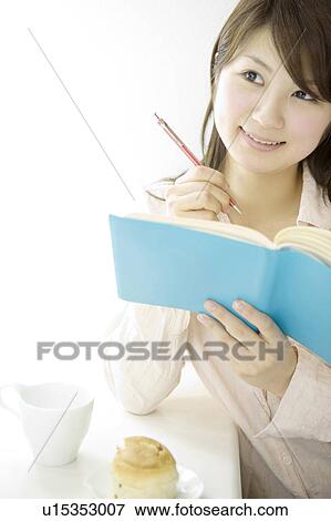 Woman who takes a note View Large Photo Image Stock Photo - Woman who takes a note. Fotosearch