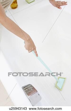 Stock Image - Woman's hand doing bathroom cleaning. Fotosearch