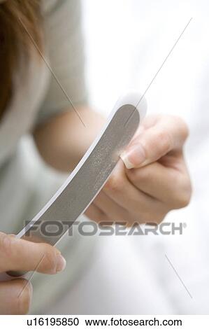 Woman doing care of her nail View Large Photo Image Stock Image - Woman doing care of her nail. Fotosearch