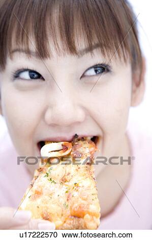 Woman eating a pizza View Large Photo Image Stock Image - Woman eating a pizza. Fotosearch