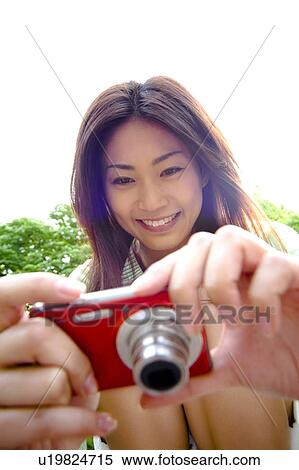Woman having a digital camera View Large Photo Image Stock Photography - Woman having a digital camera. Fotosearch