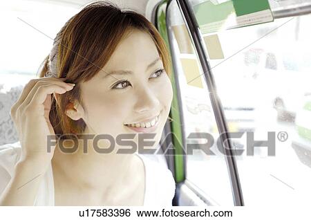 Stock Photograph - Woman in the taxi. Fotosearch