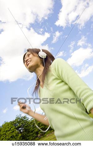 Woman listening to music View Large Photo Image Stock Photo - Woman listening to music. Fotosearch