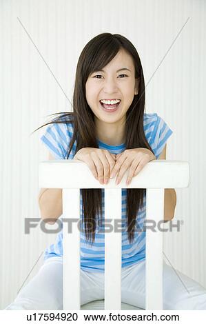 Woman taking a seat with smile View Large Photo Image Stock Image - Woman taking a seat with smile. Fotosearch