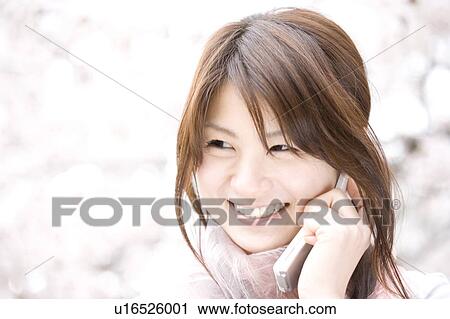 Stock Image - Woman under the cherry tree. Fotosearch