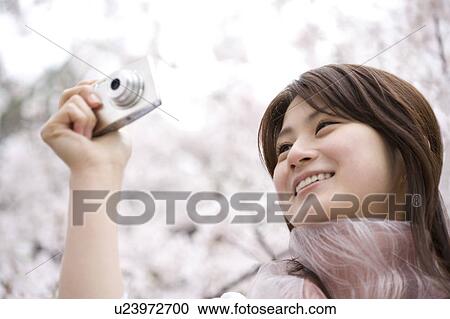 Woman under the cherry tree View Large Photo Image Stock Image - Woman under the cherry tree. Fotosearch