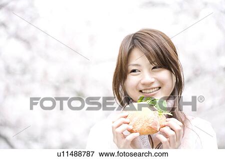 Stock Photo - Woman under the cherry tree. Fotosearch