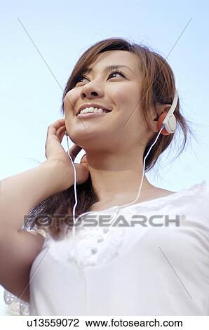 Woman who listen to the music View Large Photo Image Stock Image - Woman who listen to the music. Fotosearch