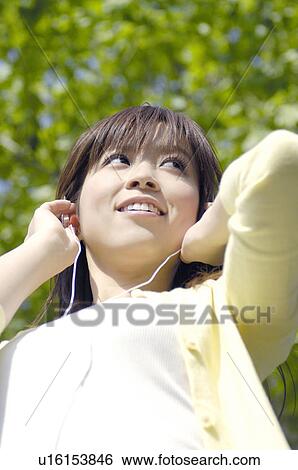 Woman who listens to the music View Large Photo Image Stock Photograph - Woman who listens to the music. Fotosearch