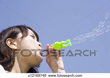 Woman who plays with the soap bubble View Large Photo Image Stock Photo - Woman who plays with the soap bubble. Fotosearch