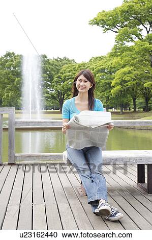 Woman who reads a newspaper View Large Photo Image Stock Image - Woman who reads a newspaper. Fotosearch