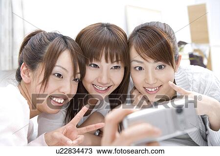 Woman who takes a photograph with a digital camera View Large Photo Image Stock Image - Woman who takes a photograph with a digital camera. Fotosearch