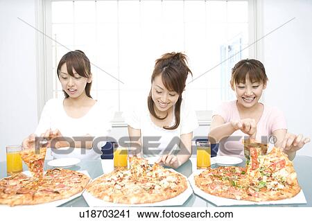 Women eating a pizza View Large Photo Image Stock Image - Women eating a pizza. Fotosearch