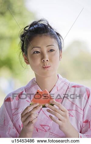 Yukata woman who eats a watermelon View Large Photo Image Stock Photograph - Yukata woman who eats a watermelon. Fotosearch