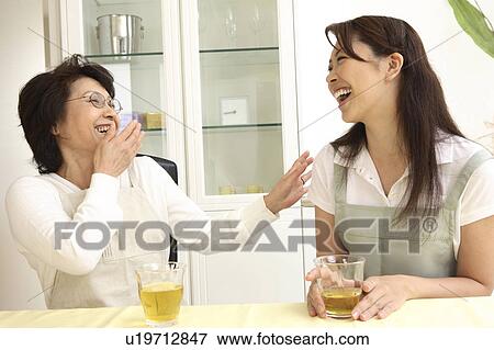 Bride and the mother-in-law having a pleasant chat View Large Photo Image Stock Photo - Bride and the mother-in-law having a pleasant chat. Fotosearch