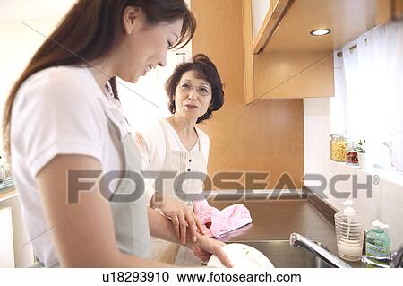 Bride and the mother-in-law washing tableware View Large Photo Image Stock Image - Bride and the mother-in-law washing tableware. Fotosearch