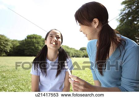 Stock Image - Parent and child who eats lunch. Fotosearch