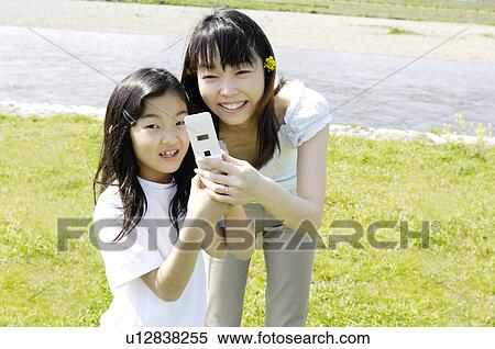 Parent and child who play with cell phone View Large Photo Image Stock Photography - Parent and child who play with cell phone. Fotosearch