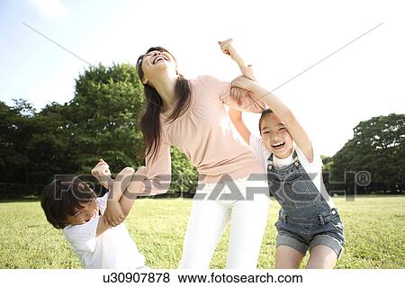 Stock Photo - Parent and child who plays at the park. Fotosearch