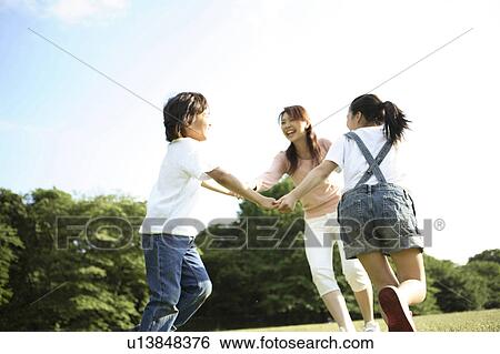 Parent and child who plays at the park View Large Photo Image Stock Photograph - Parent and child who plays at the park. Fotosearch