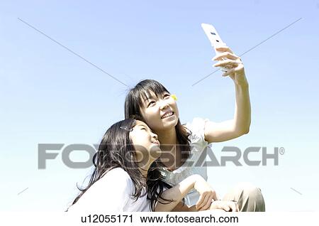 Stock Image - Parent and child who sees a portable. Fotosearch