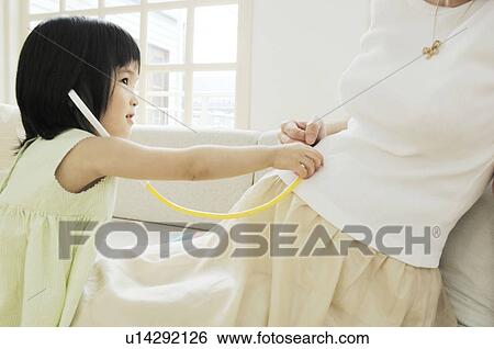 Stock Photograph - Pregnant mother and daughter. Fotosearch