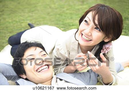 Couple liying on the ground View Large Photo Image Stock Photo - Couple liying on the ground. Fotosearch