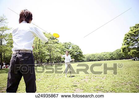 Couple who does frisbee at the park View Large Photo Image Stock Photo - Couple who does frisbee at the park. Fotosearch