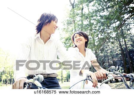 Couple who enjoys a cycling View Large Photo Image Stock Photography - Couple who enjoys a cycling. Fotosearch